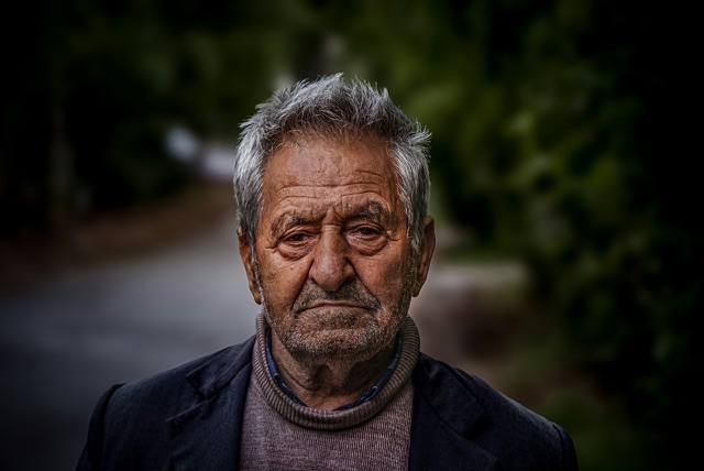 Before: Close-up street portrait of an older man with gray hair