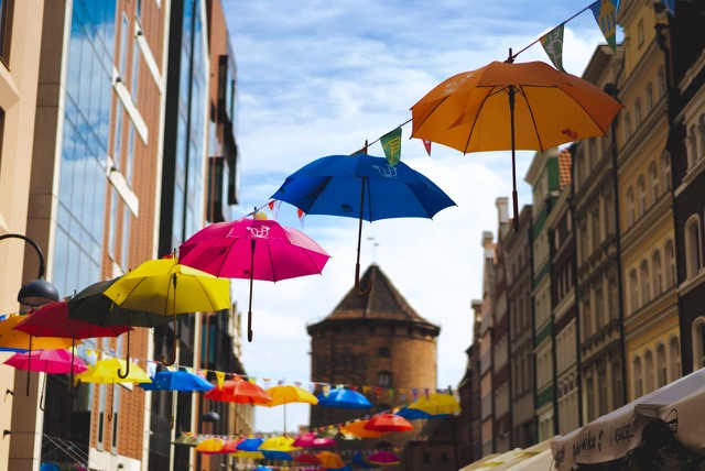 After: Colorful umbrellas suspended above a city street, edited with the free Color Boost LUTs