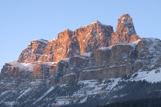 Before: Rugged mountain peak lit by warm sunrise light