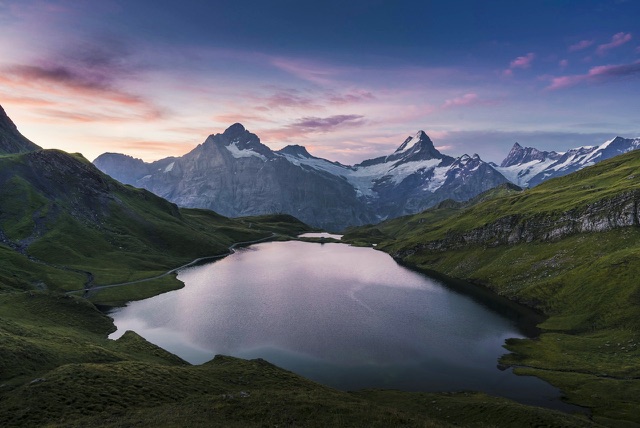 After: Alpine lake beneath snow-capped mountains at twilight, edited with the free Landscape LUTs