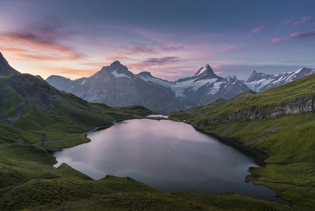 Before: Alpine lake beneath snow-capped mountains at twilight