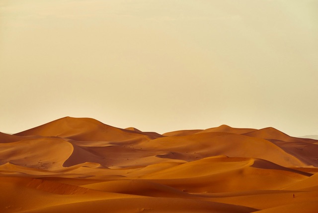 After: Rolling desert sand dunes under a hazy sky, edited with the free Landscape LUTs