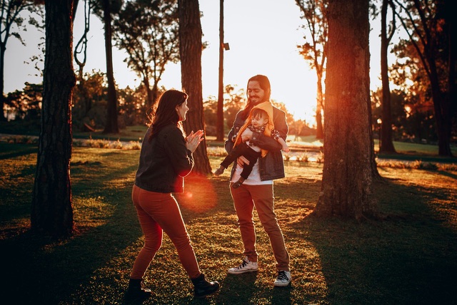 Before: Family playing in a park at golden hour