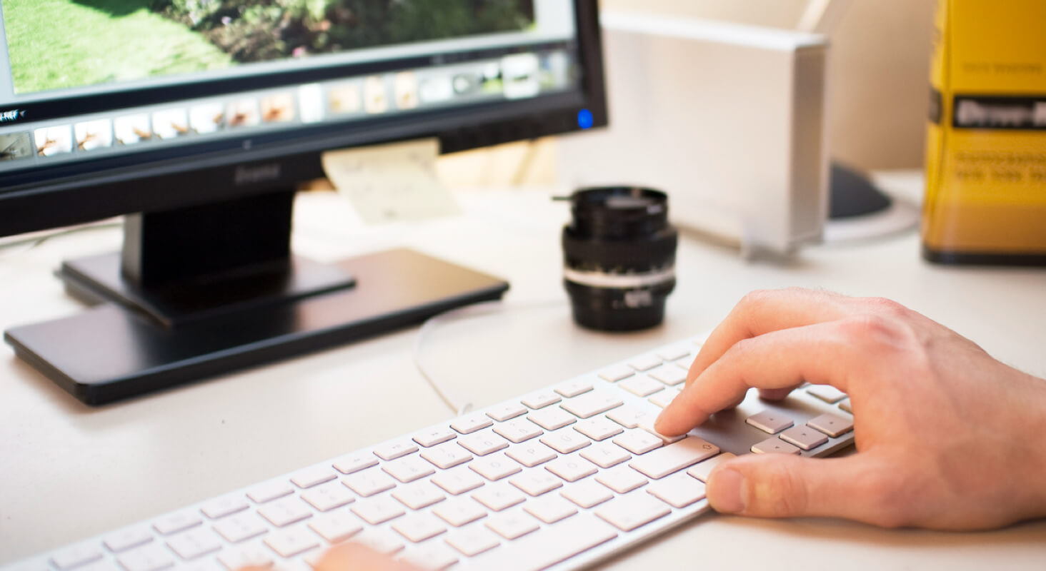 Editing family photos on a computer using professional photo editing software.