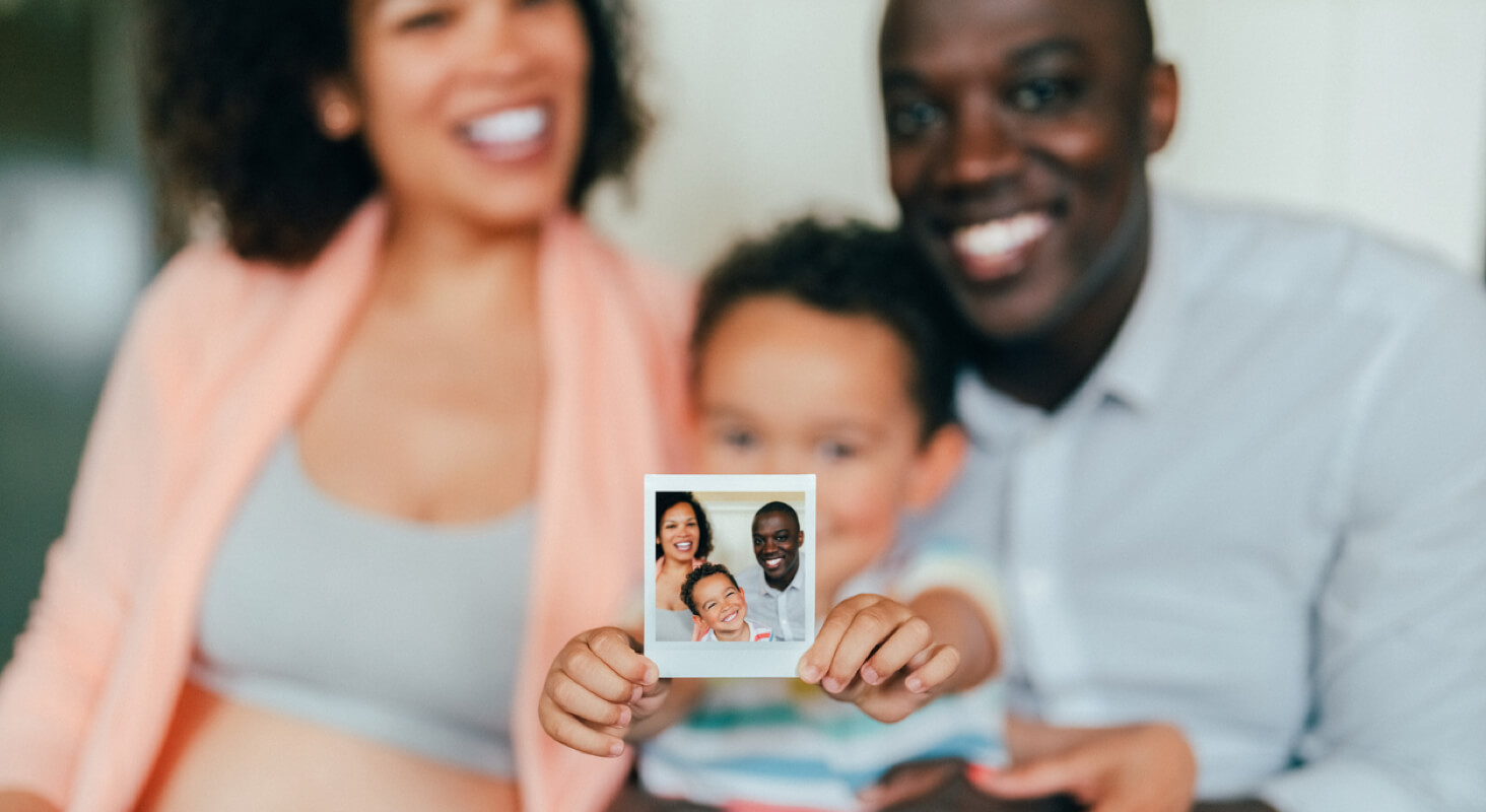Family holding a printed photo.